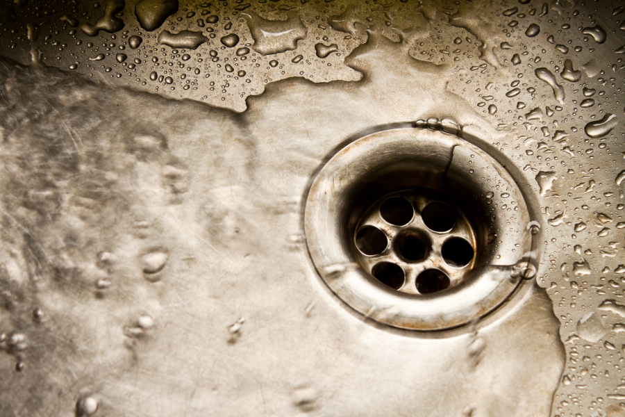 Plumbing repair service. Plumbing repair service. Professional installer with spanner checking pipe.
